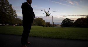 In this November 2019 photo, a U.S. Secret Service special agent stands as Marine One, with President Donald Trump aboard, lifts off from the South Lawn of the White House in Washington. The White House is throwing its support behind a plan to relocate the U.S. Secret Service in order to better focus on the growing threat of online financial crimes. Shifting the agency from within the Department of Homeland Security to the Treasury Department would require action from Congress. AP Photo by Alex Brandon