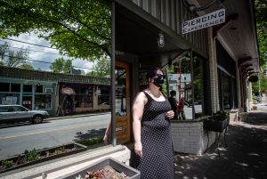 Christina Blossey stands in front of her body piercing business, Piercing Experience, in Atlanta. Blossey says her business is likely to remain closed until she can be assured that she can acquire masks and cleaning materials regularly to keep her customers safe. Georgia Gov. Brian Kemp announced a plan to allow certain businesses to reopen this weekend. AP Photo by Ron Harris